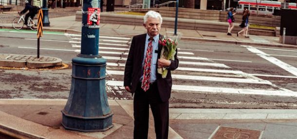 Man holding bouquet of red roses