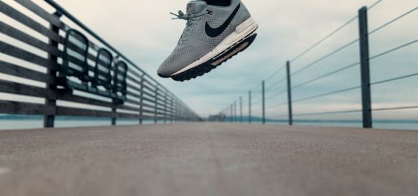 A person wearing gray Nike shoes